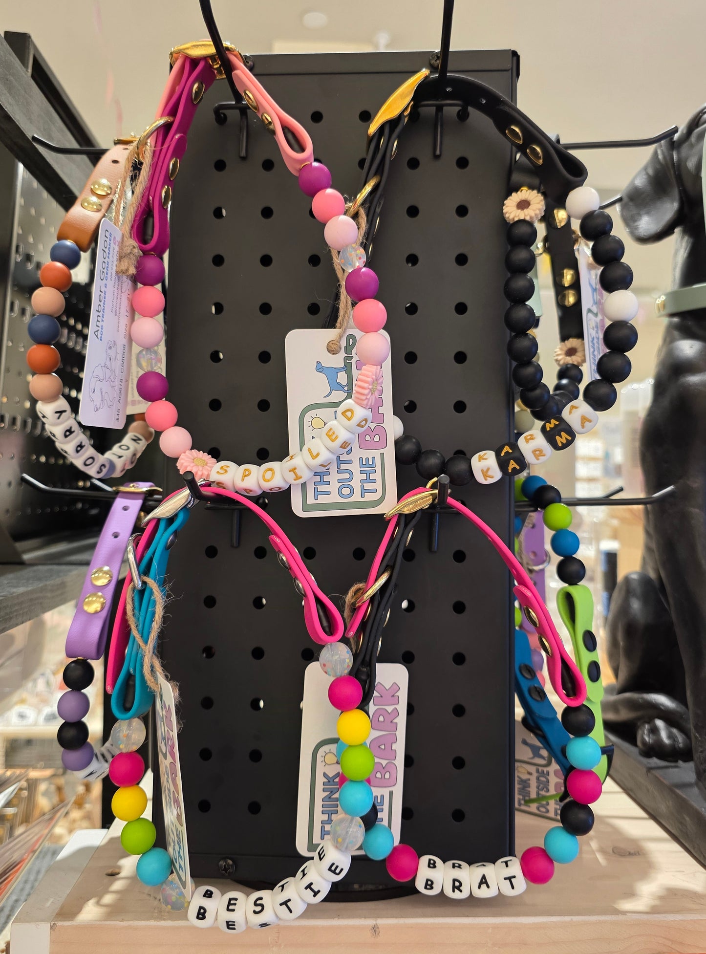 Handmade custom biothane dog collar with colorful silicone beads and personalized name letters.
